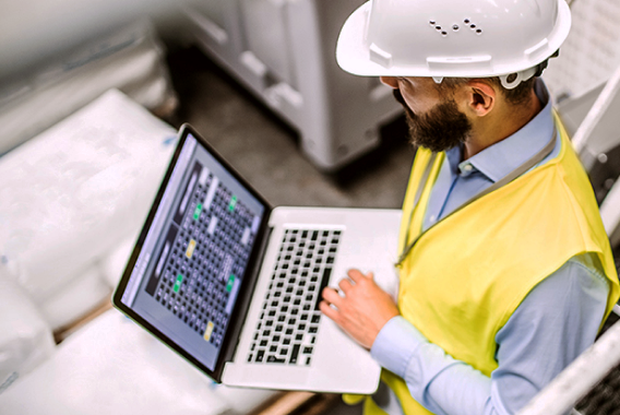 Worker Using Laptop for Smart Building Internet Setup​​