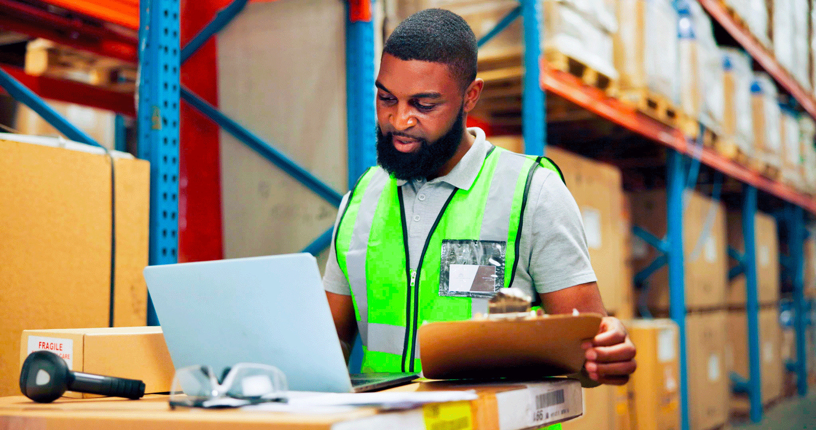 Man working in a laptop in the warehouse