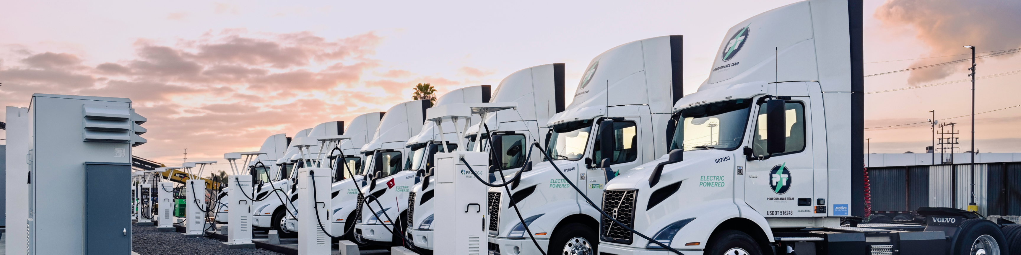 Row of EV trucks charging